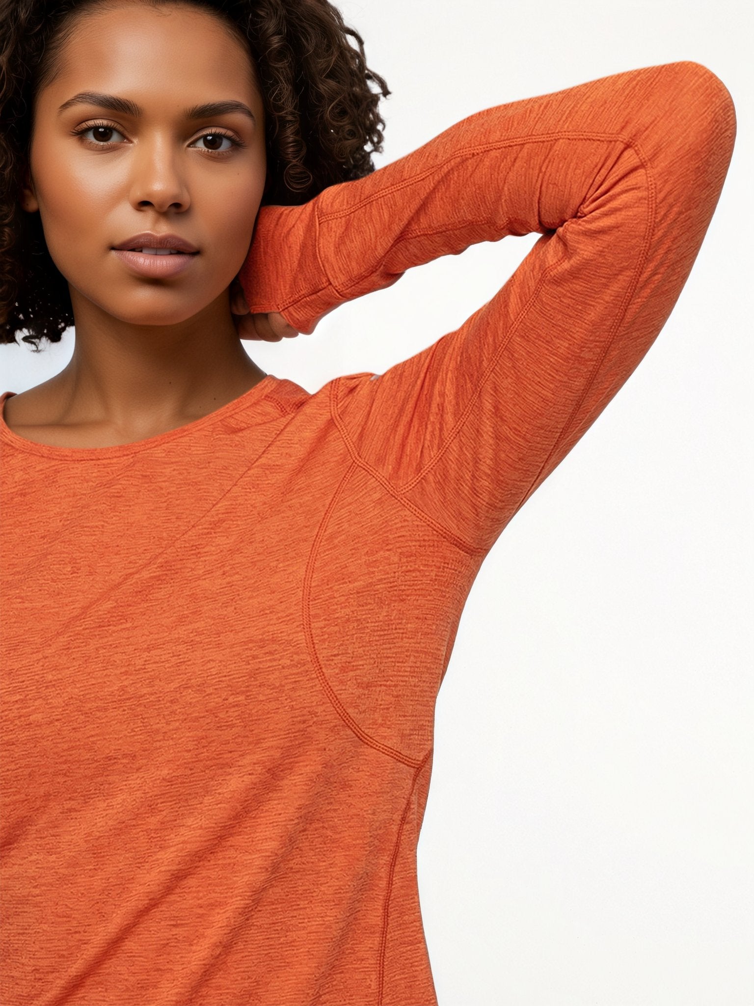 Performance long sleeve top lifestyle image 08: black orange stretching